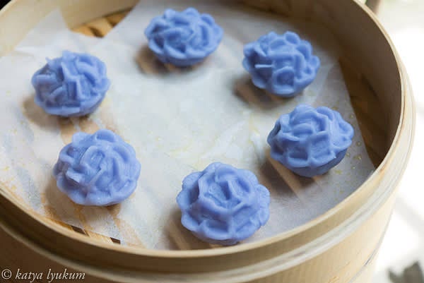 Shape the dough into a cylinder 1" D and divide it into 12 portions 1" long. Shape each piece into a ball. Keep them covered with a damp towel or plastic wrap to prevent drying. Line bamboo baskets with lightly oiled parchment paper. Shape dumplings one by one and place them into the baskets. Flatten each portion of dough into a round wrapper, place 1 tsp of filling in the center, and shape it into a ball. Using flat tongs, pinch petals.