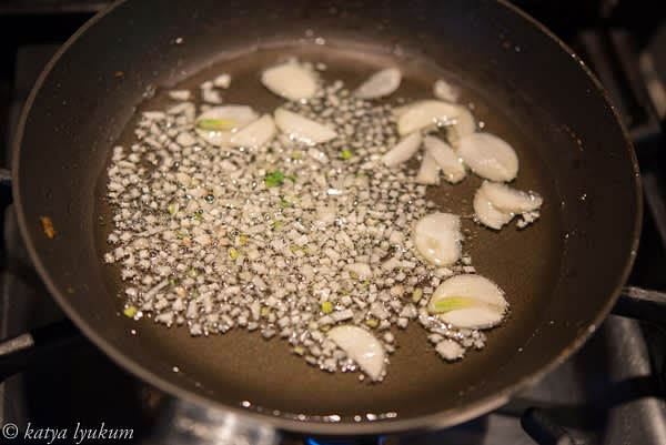 In a small skillet or saucepan, heat oil over low heat. Add minced or sliced garlic and slowly caramelize it until lightly golden. Strain oil and use it for other recipes.