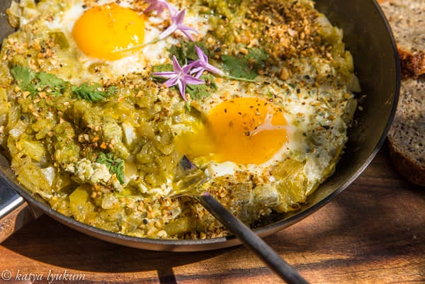 Spoon eggs with sauce into individual plates and serve with yogurt or labneh, sprinkled with dukkah.