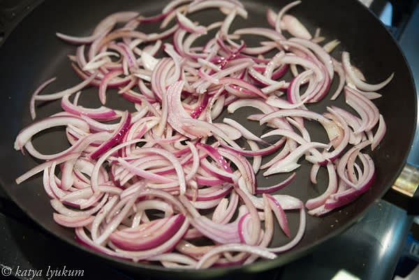 Cut onion in half lengthwise, cut off the ends, and slice into slivers. Mince garlic. Add 1 tbsp of olive oil to the hot skillet and saute onions and garlic until soft, sweet, and fragrant.