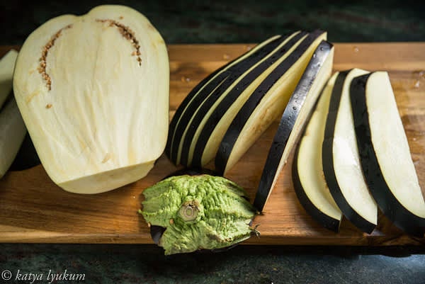 Remove the stem end and cut the eggplant in half lengthwise. Slice each half lengthwise 0.25-0.3" thick.