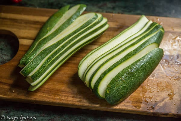 Remove the stem end and slice the zucchini lengthwise 0.25" thick.