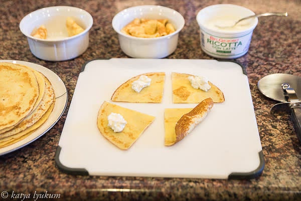 Preheat oven 275F. Quarter 4 crepes. Fold 1 tsp of cheese into each quarter.