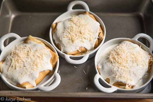 Place it bottom side up in the ramekin and repeat with the other three. Spread 1/4 cup of Bechamel on top of each crespelle and sprinkle with 1 tbsp (or more) of grated cheese.