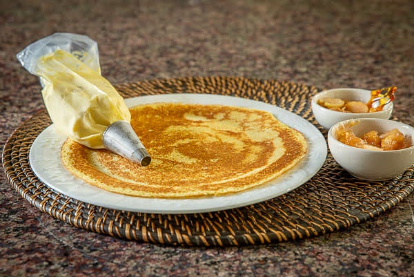 Fill a pastry bag with creme brulee.