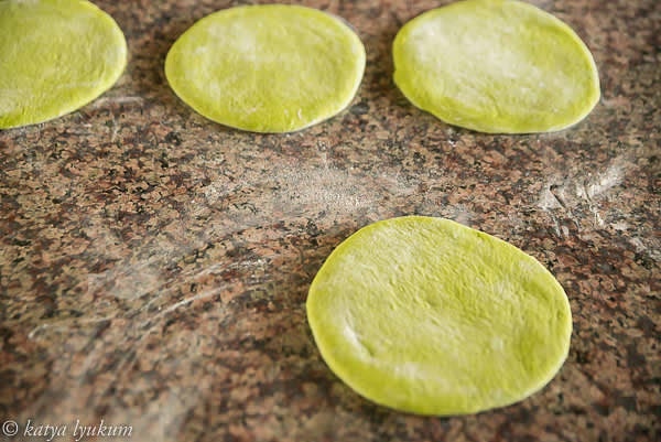 Using a rolling pin, roll out each portion of dough into a 1/4" thin disc, let rest, and roll again 1/8" thin.