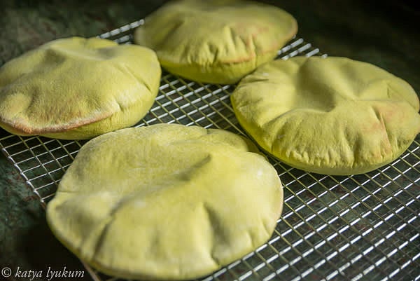 Bake in a preheated oven 500F (450F convection) for 5-6 minutes. Carefully transfer puffed pita bread on a cooling rack using a peel. Cover with a kitchen towel, let cool to room temperature and slowly deflate.