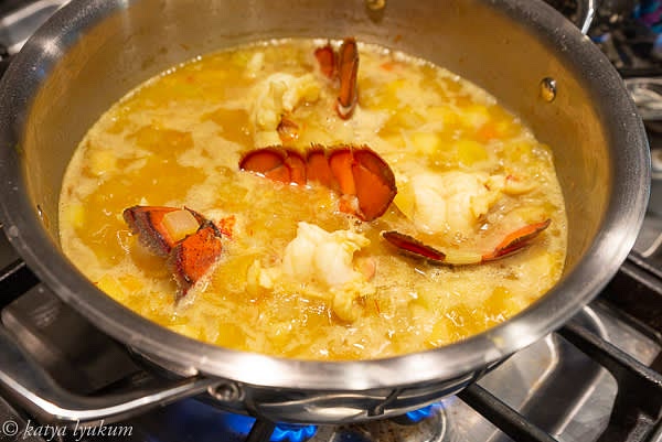 If serving lobster tails, clams, or mussels, cook them until done and reserve.