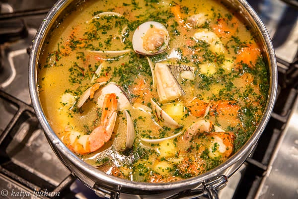 Add bite-size fish pieces in order of how long they will take to cook. Monkfish and sea bass will take a few minutes longer than the rest of the fish, so start with them. When ready to serve, taste and adjust seasoning. Garnish with freshly chopped parsley and fennel fronds or other herbs.