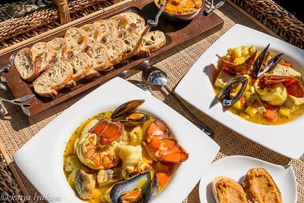 Traditionally, French restaurants serve bouillabaisse not plated, letting the guests assemble their dishes right before eating — large dishes with cooked seafood, fish stock, rouille, and baguette toasts. Each eater places some seafood and potatoes in a bowl, adds some stock, spreads some rouille on a couple of toasts, and places them on top of the stock to soak the flavorful essence of bouillabaisse. Other restaurants prefer serving it as a dinner that consists of 3-4 plated dishes featuring different kinds of seafood and making sure all components are distributed evenly. Either way, this fish stew is fantastic! Bon appetite!