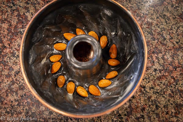 Preheat the oven 325F. Butter the mold generously with butter. Place the soaked almonds on the bottom, one almond per cavity.