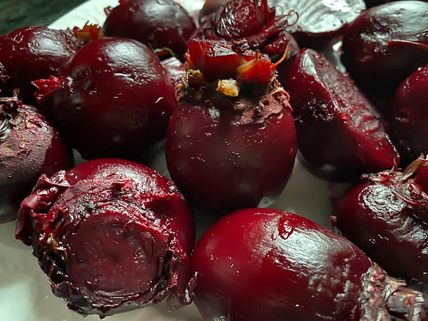 Let cooked beets cool down to room temperature. To avoid staining your hands while removing the skin of the beets, wear disposable gloves. Using your fingertips, rub the skin off.