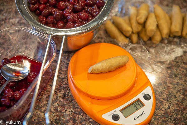 Give the frozen pitted sour cherries about 12 hours to thaw in a bowl in a fridge, then strain the juice to use it for other purposes. Combine cherries and corn starch. Option 1. Roll the dough 3mm (1/8") thick, ~ 6" wide, and ~ 22" long. Cut it to 15 strips 1.5" wide and 6" long. Option 2. Divide the dough into 15 portions 34-35g each. Shape them into logs and cover them with plastic wrap to prevent drying.