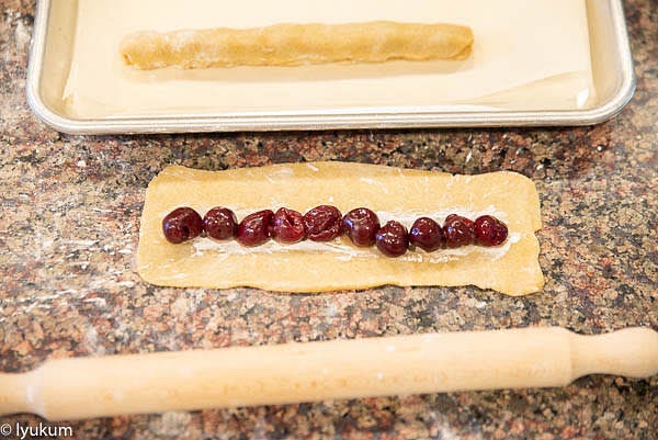 Place 10 cherries on each strip of the dough.