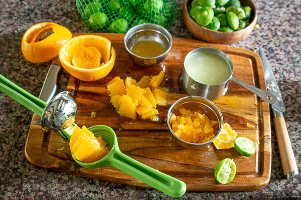 Juice key limes and orange. Reserve enough orange segments to dice a quarter of the cup. Remove seeds and membranes and finely chop serrano pepper.