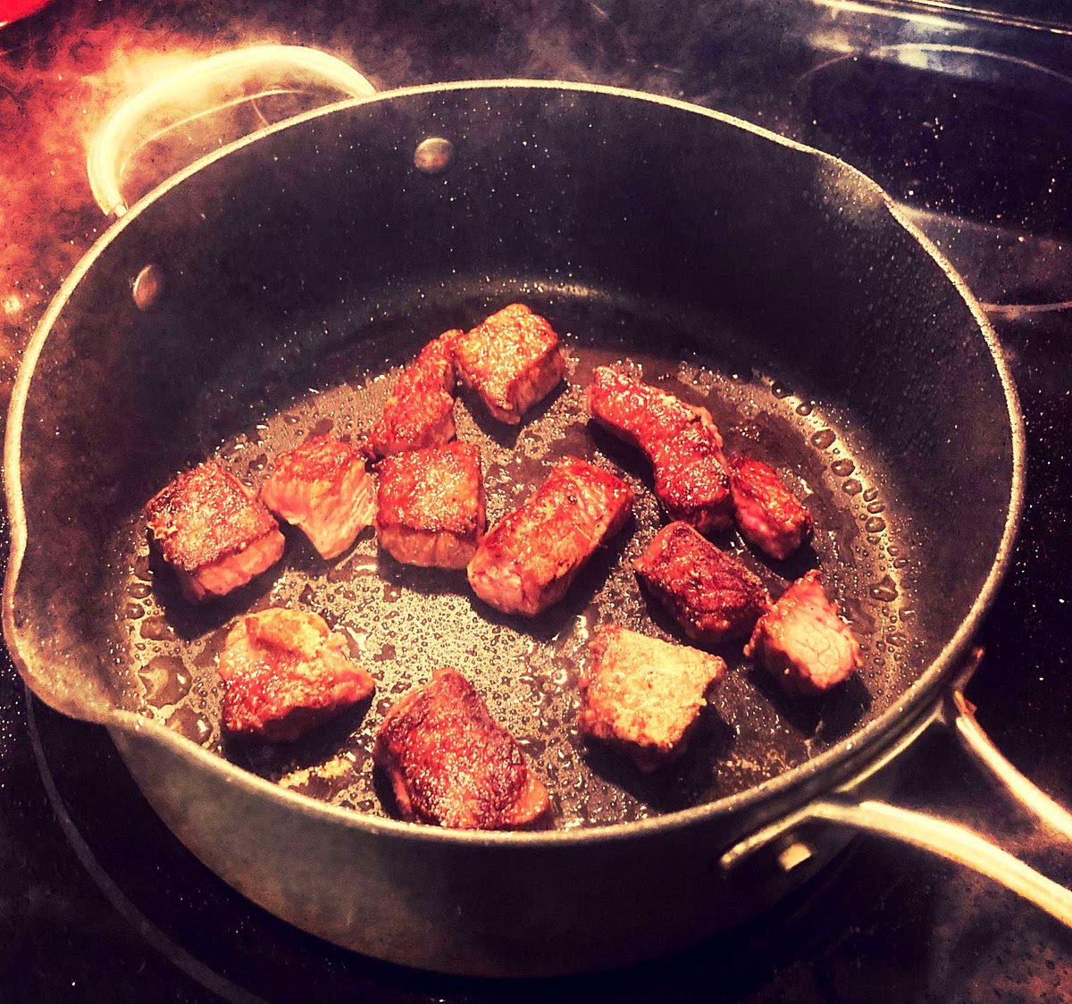 Heat a large, heavy skillet (preferably cast iron) or wok over high for 3 minutes. Swirl in 2 tablespoons vegetable oil. Working in batches to avoid crowding pan, brown meat, about 1 minute per side. Transfer to a plate.