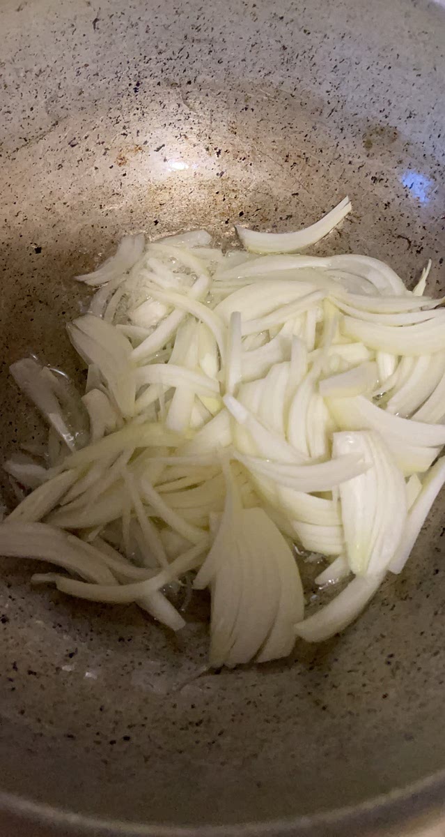 In a pot add some oil & sliced onions and saute until translucent.