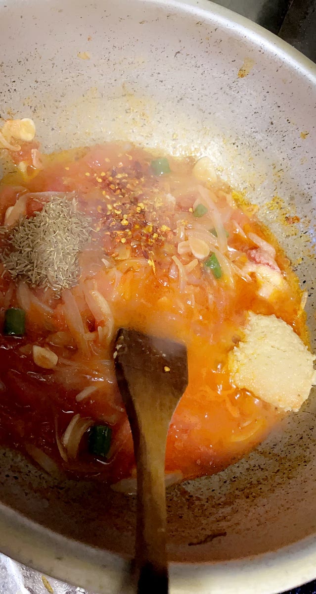 Add the spices and one can of tinned tomatoe and cook on medium heat