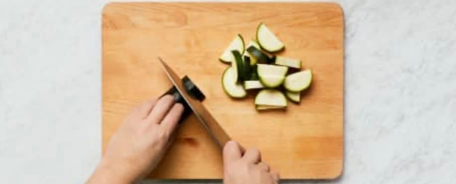 Adjust rack to middle position (middle and top positions for 4 servings) and preheat oven to 450 degrees. Wash and dry produce. Trim and halve zucchini lengthwise; cut crosswise into ¾-inch-thick half-moons. Core, deseed, and dice bell pepper into ½-inch pieces. Cut tomato into ½ inch thick wedges.
