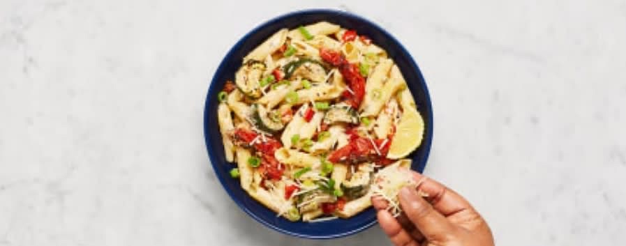 Divide pasta between bowls. Top with scallion greens and remaining Parmesan. Serve with remaining lemon wedges on the side.