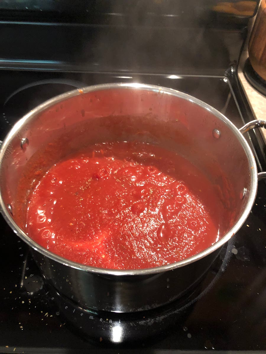 Simmer garlic in 1 tsp olive oil until fragrant. Add all other ingredients to the pot and simmer (I purée the whole tomatoes but you can break them up if you prefer chunky sauce).
