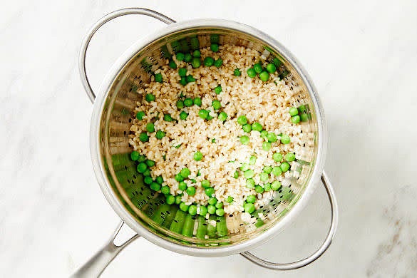 Read through the recipe. Heat the oven to 200C, fan-forced. Fill a medium saucepan three-quarters full with water and bring to the boil for the rice. Cook the rice in the pan of boiling water for 26 mins or until tender. Add the peas to the rice, return to the boil and cook for 1 min. Drain.
