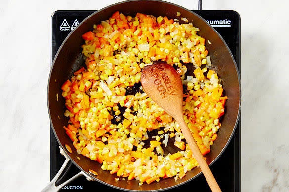 Heat 2 tbs oil in a large deep frypan over medium-high heat. Cook the onion, carrot and corn, stirring occasionally, for 4-5 mins until softened.