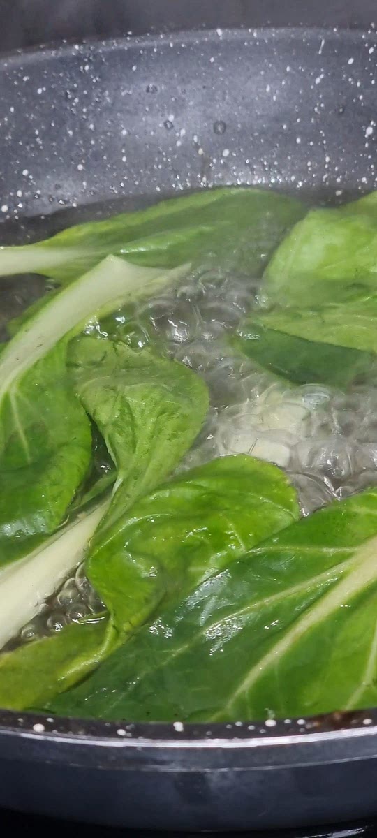 Boil bok choy for a few minutes until the leaves wither