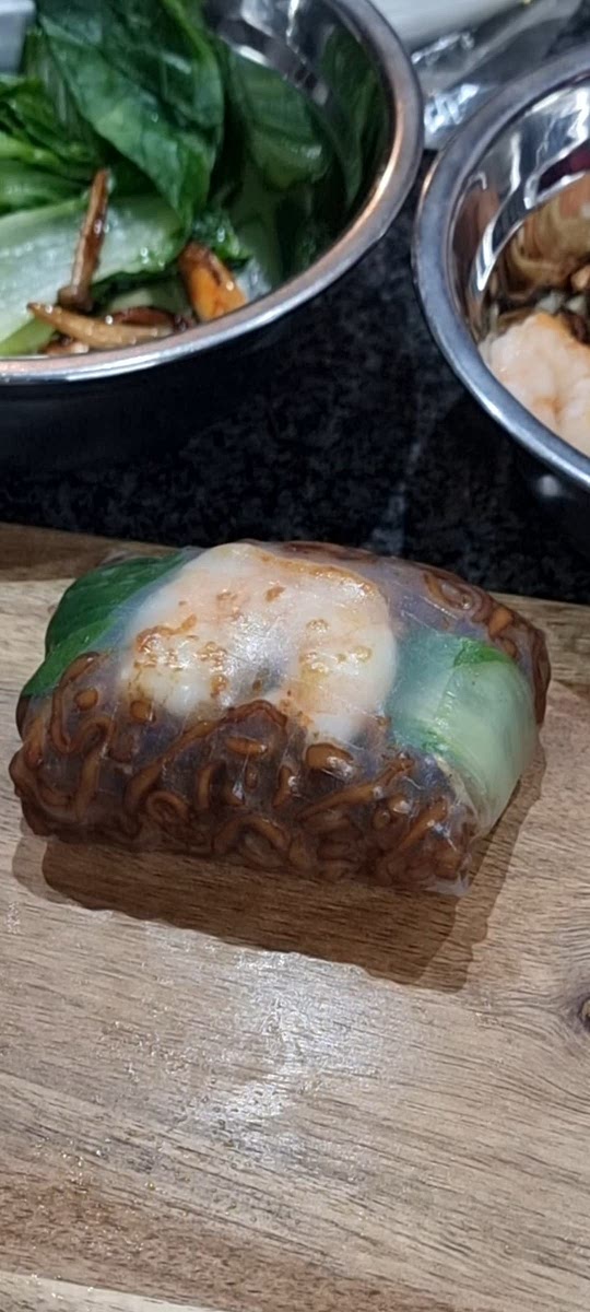 Build your rice paper spring rolls by first adding rice paper to water to make them soft and workable, add all ingredients and roll up