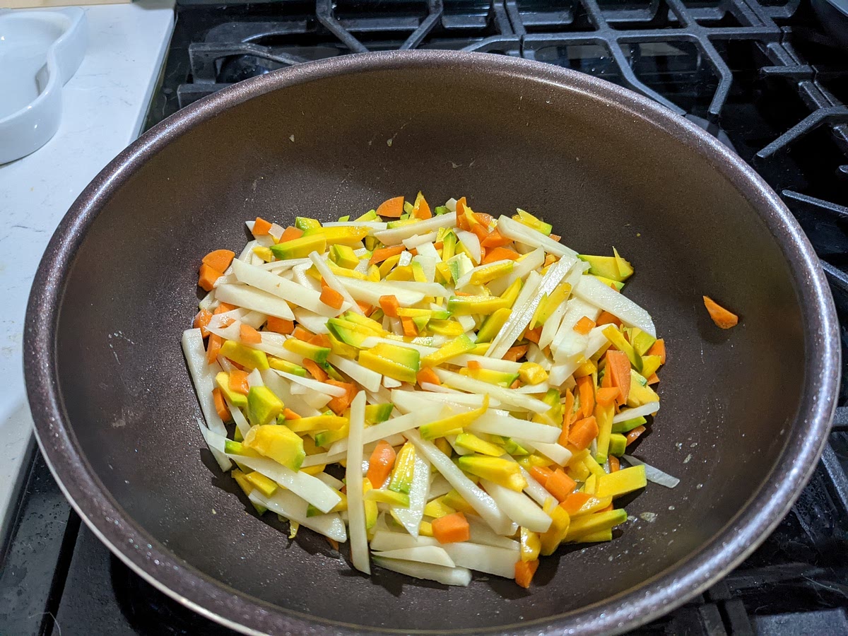 2. バター（ギー）をフラインパンに入れ、細切りした野菜を炒める