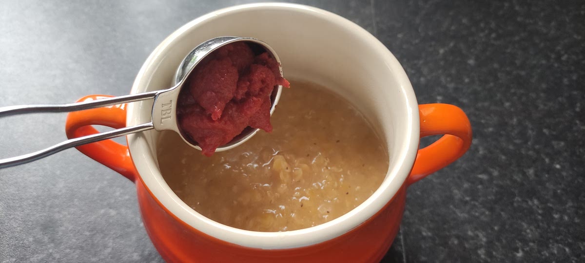 Pour the lentils and any water from the pan into a bowl and stir in a tablespoon of tomato puree