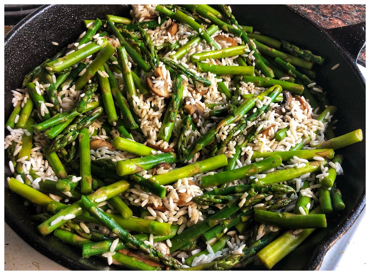 Add rice to the skillet when both ingredients are coated well in the oil. Let the rice cook with the asparagus and mushrooms for about 5 minutes or until the rice starts to get a little brown on the edges.
