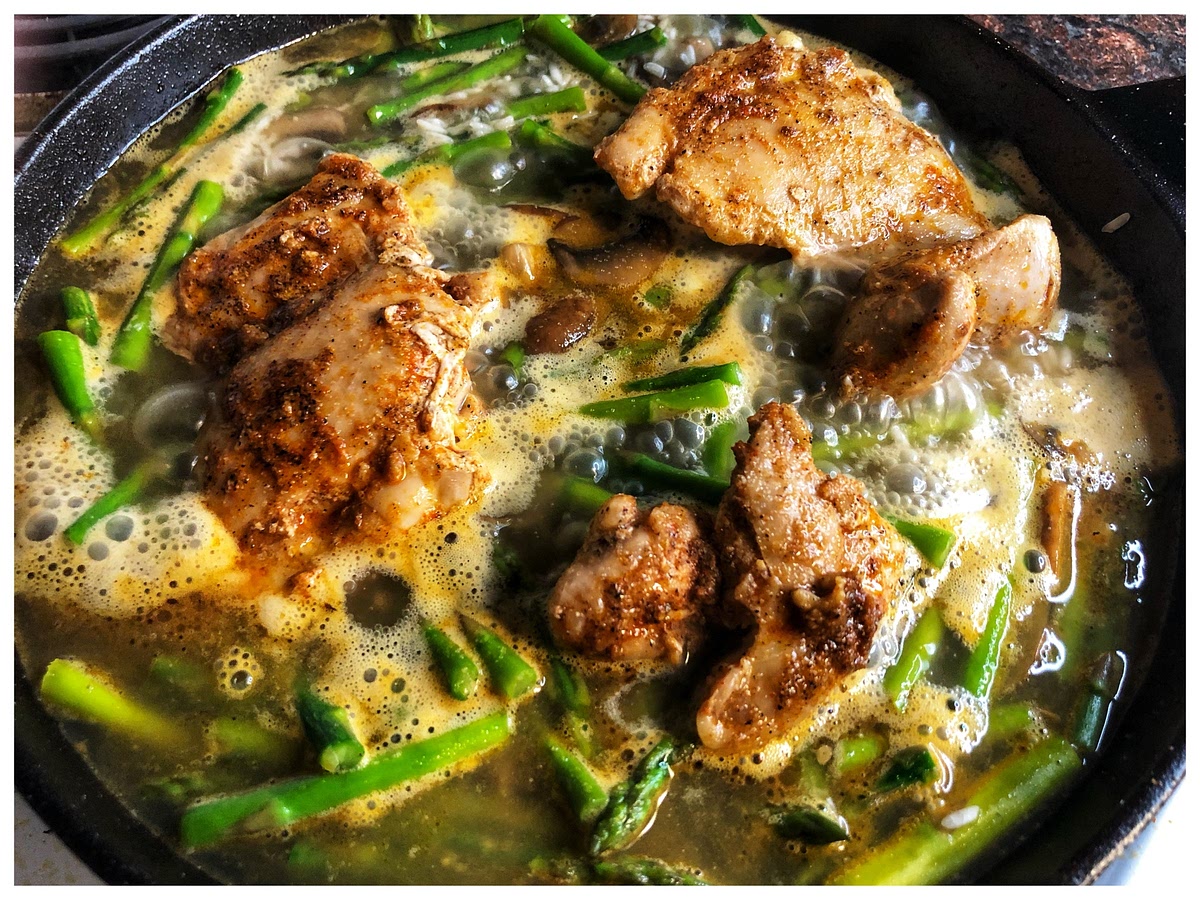 Pour the 2 cups of water into the skillet to cover the asparagus, mushrooms, and rice.