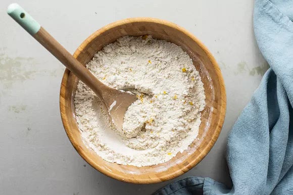 In a small bowl, mix the flour, sugar, citrus zests, and salt together. Stir the mixture into the yeast and eggs.