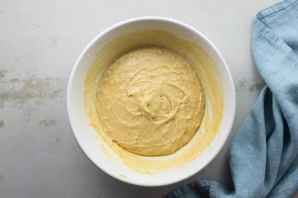 Work the mixture in the bowl with a spatula until it holds together. On a very lightly floured surface, knead the dough with the softened butter until it becomes soft and elastic, about 5 minutes. The dough will be very sticky. Cover the dough and allow it to rise until it doubles in size, about 1 hour.