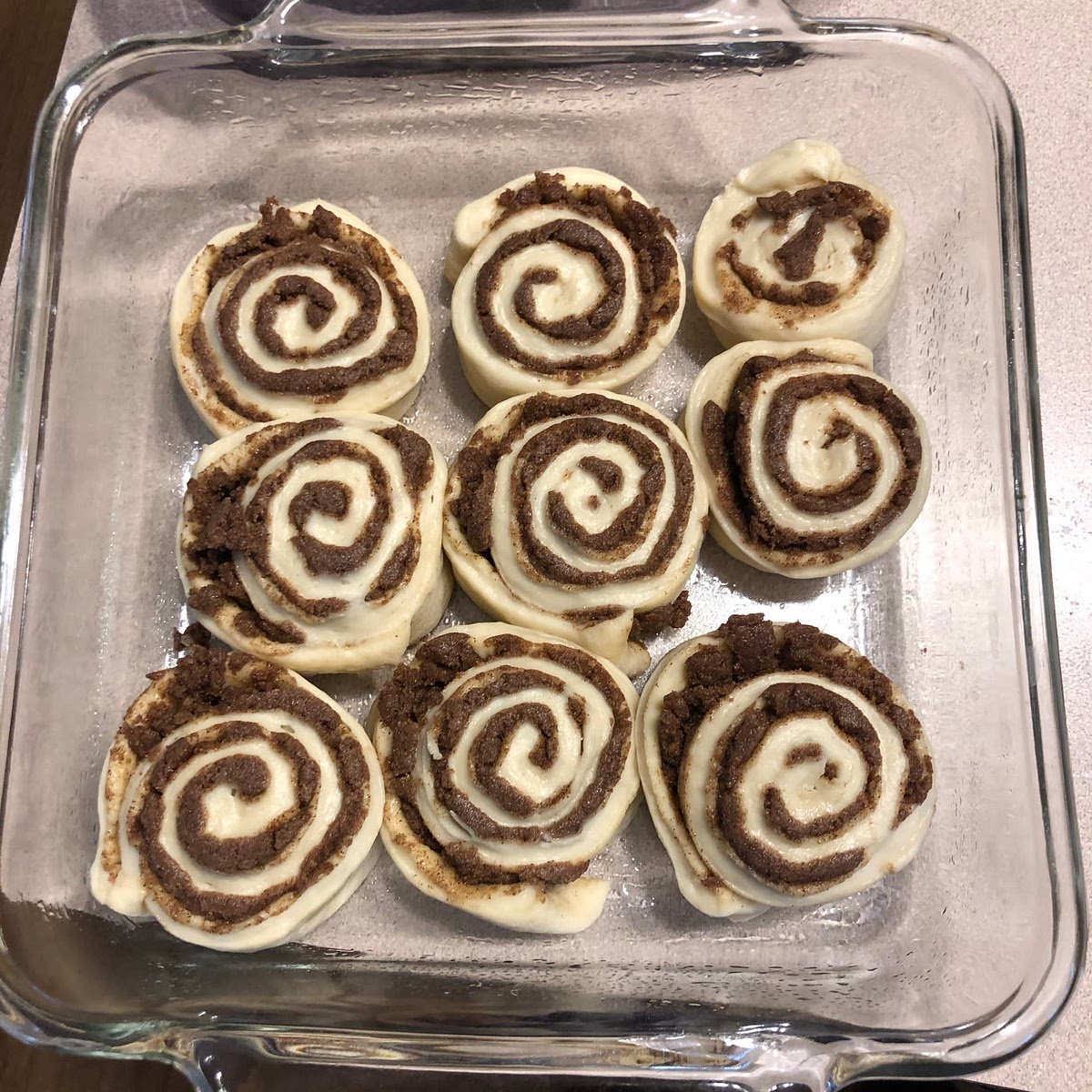 Arrange in prepared pans and cover with plastic wrap. Let rise 35-40 minutes.