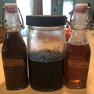 Mix ingredients except vanilla and maple extract into a saucepan and whisk. Heat until the sugar dissolves. Take off the heat and add vanilla and maple extract. Pour into a jar or bottle.
