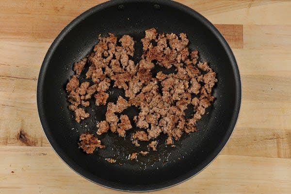 Cook the Sausage. Return pan with reserved garlic oil to medium heat.Add Italian sausage to hot pan and stir often, breaking up meat, until no pink remains and sausage reaches a minimum internal temperature of 160 degrees, 4-6 minutes.
Remove from burner. Remove sausage to a plate. Reserve pan; no need to wipe clean.