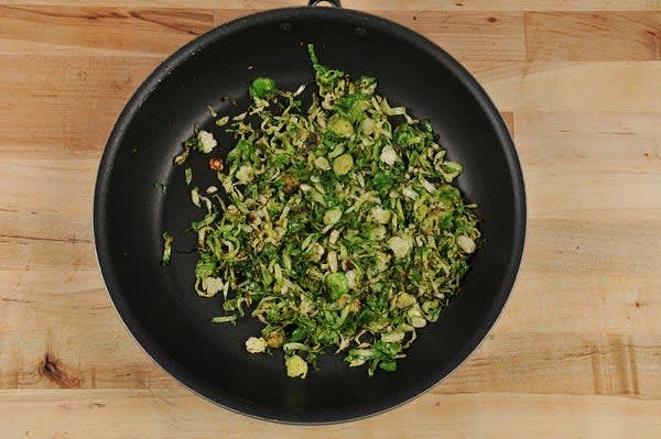 Cook the Brussels Sprouts. Return pan used to cook sausage to medium heat and add 2 tsp. olive oil. Add Brussels sprouts and a pinch of salt to hot pan. Stir occasionally until lightly browned and tender, 5-8 minutes.