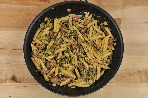 Add sausage and white wine to hot pan. Cook until wine is almost evaporated, 30-60 seconds. Add reserved pasta cooking water, chicken demi-glace, and cream. Bring to a simmer. Once simmering, cook until slightly thickened, 1-2 minutes. Remove from burner. Stir in pasta and a pinch of salt and pepper. Plate dish as pictured on front of card, garnishing pasta with garlic chips. Bon appétit!