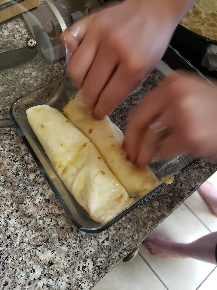 Roll the tortilla and place seam side down in 8x8-in baking dish.