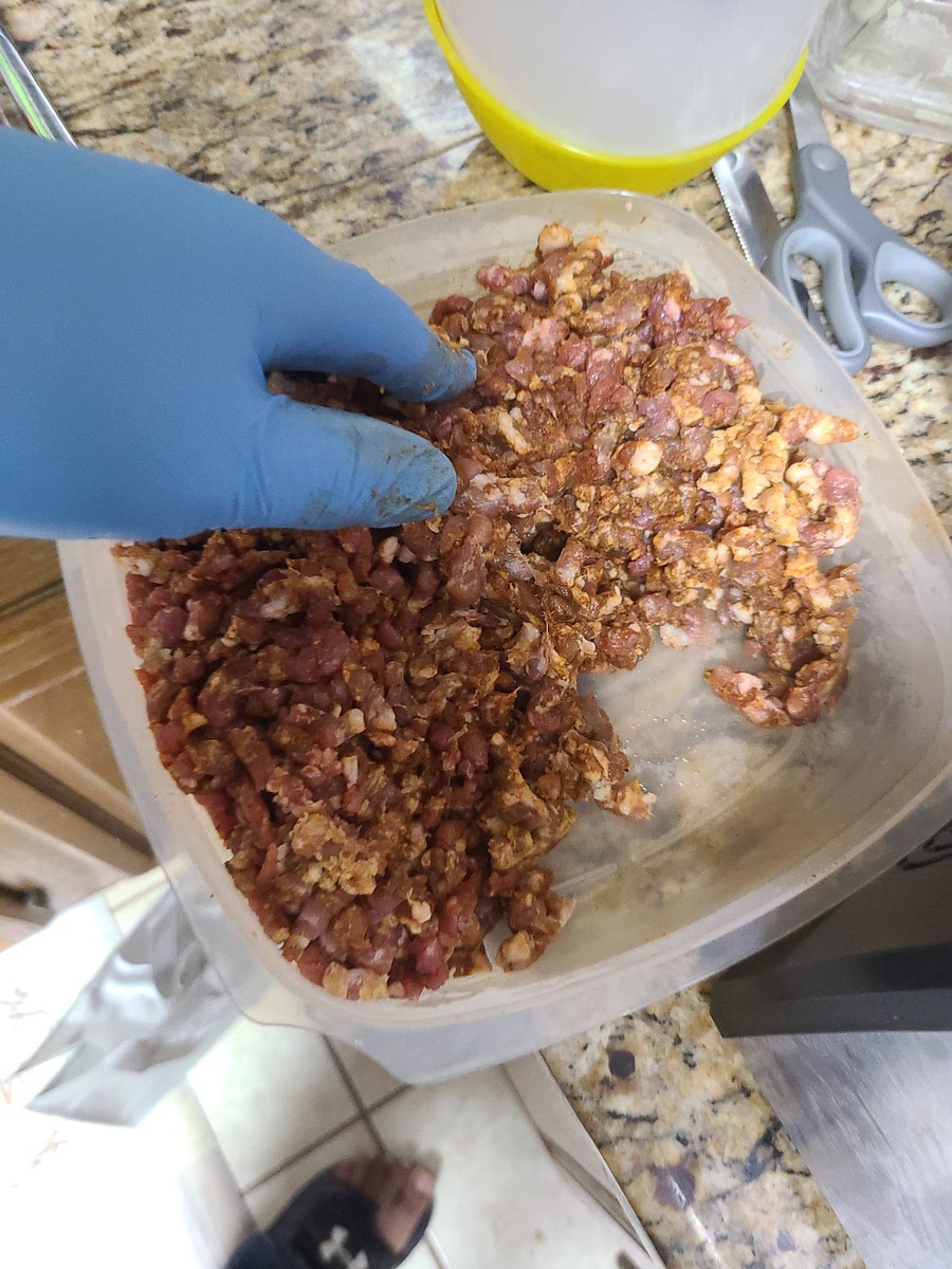 Assemble the meat grinder fitted with the coarse plate. Grind all ingredients into a bowl.