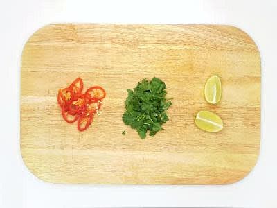 Slice the red chilli[es] into rounds Cut the remaining lime into wedges Cut the baked sweet potatoes in half, lengthways, and fill with the creamy curry Garnish with the chilli rounds (can't handle the heat? Go easy!), toasted cashew nuts and a lime wedge Enjoy!