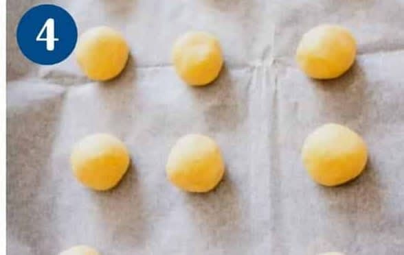 Divide the dough into small golf size balls. You should get about 2 dozen. Pro tip - If the cookie dough is too dry and cracking - Add one to two tablespoon of water and try again.