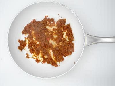 Once the onion has started to soften, add the chopped garlic, chopped ginger, curry powder and ground paprika to the pan, then cook for 1-2 min or until fragrant Once fragrant, add the diced tomato and cook for 3-4 min or until the veg has broken down to make a thick sauce