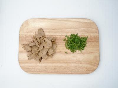 Whilst the sauce is thickening, cut the meat-free chicken bites into small bite-sized pieces Chop the coriander finely, including the stalks