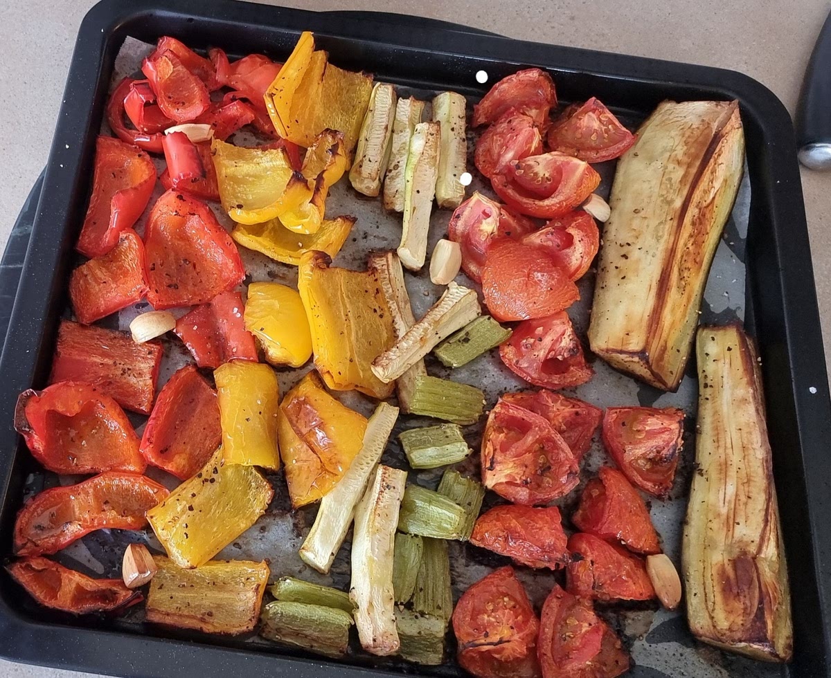 Chop all the vegetables onto a tray with the garlic, add salt pepper and oil
