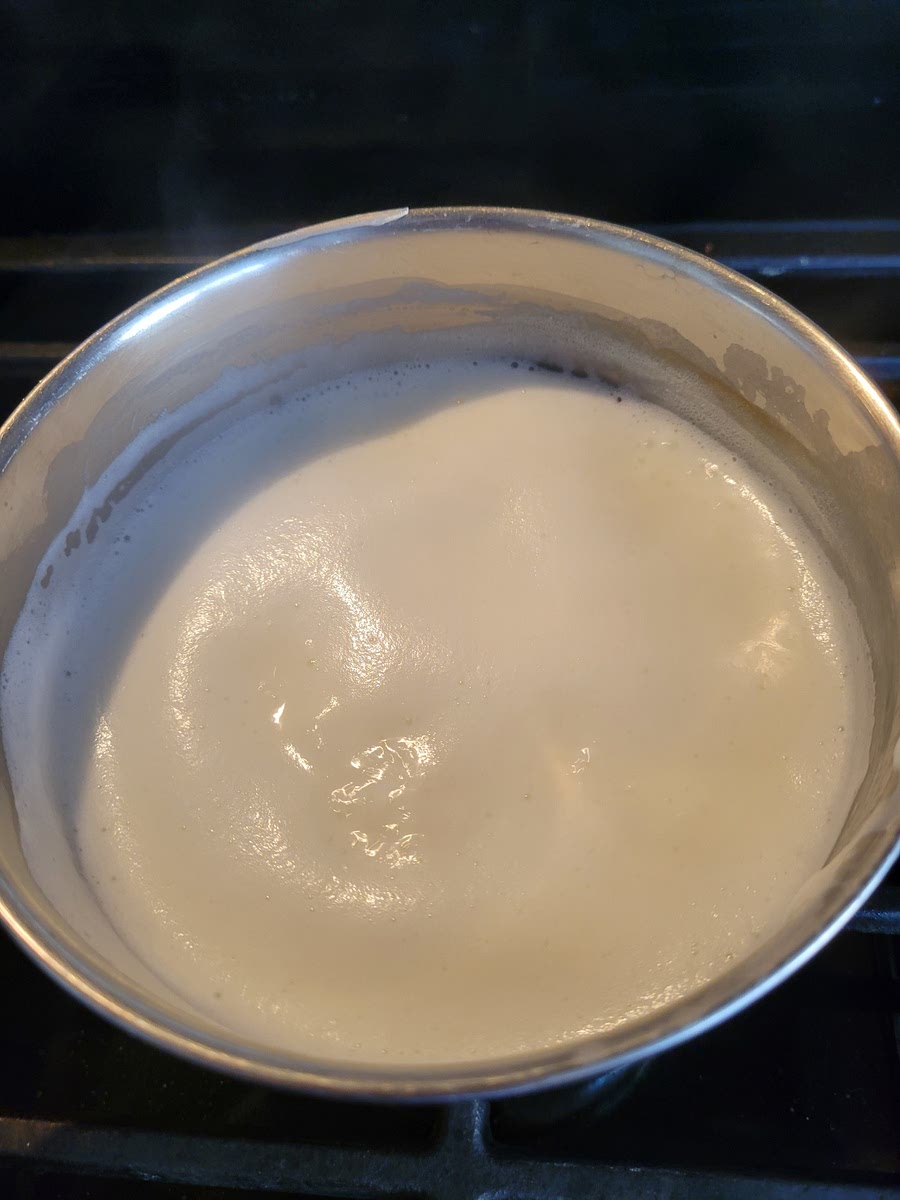 PUT MILK IN A SMALL SAUCEPAN OVER MEDIUM HEAT. BRING TO A BOIL AND REMOVE FROM HEAT. ALLOW TO COOL SLIGHTLY. (OR YOU CAN HEAT IT IN THE MICROWAVE UNTIL BOILING, ABOUT 3 MINUTES.)