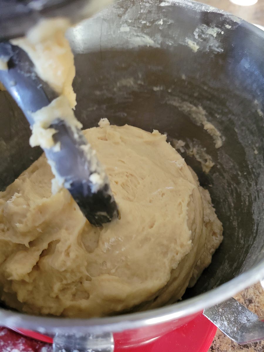 ADD ADDITIONAL FLOUR 1/2 CUP AT A TIME UNTIL DOUGH BEGINS TO SEPARATE FROM THE SIDES. LET REST FOR A FEW MINUTES.
