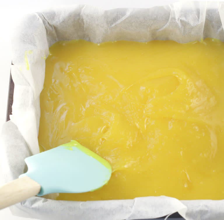 Remove from heat and pour the lemon layer onto the baked shortbread crust and evenly spread with a spatula. Allow to cool on the counter for about 30 minutes and then pop it in the fridge to cool for 1 - 2 hours, or overnight until completely chilled. When chilled you can remove bars from the pan and slice. Sprinkle the bars with powdered sugar if desired, just before serving. Store lemon bars in an air-tight container in the fridge for up to 1 week.